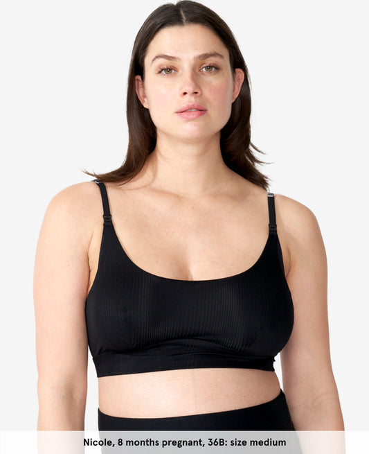 Pregnant model wearing a black clip down nursing bra, labeled as Nicole, 8 months pregnant, 36B, size medium. Shown in Black.