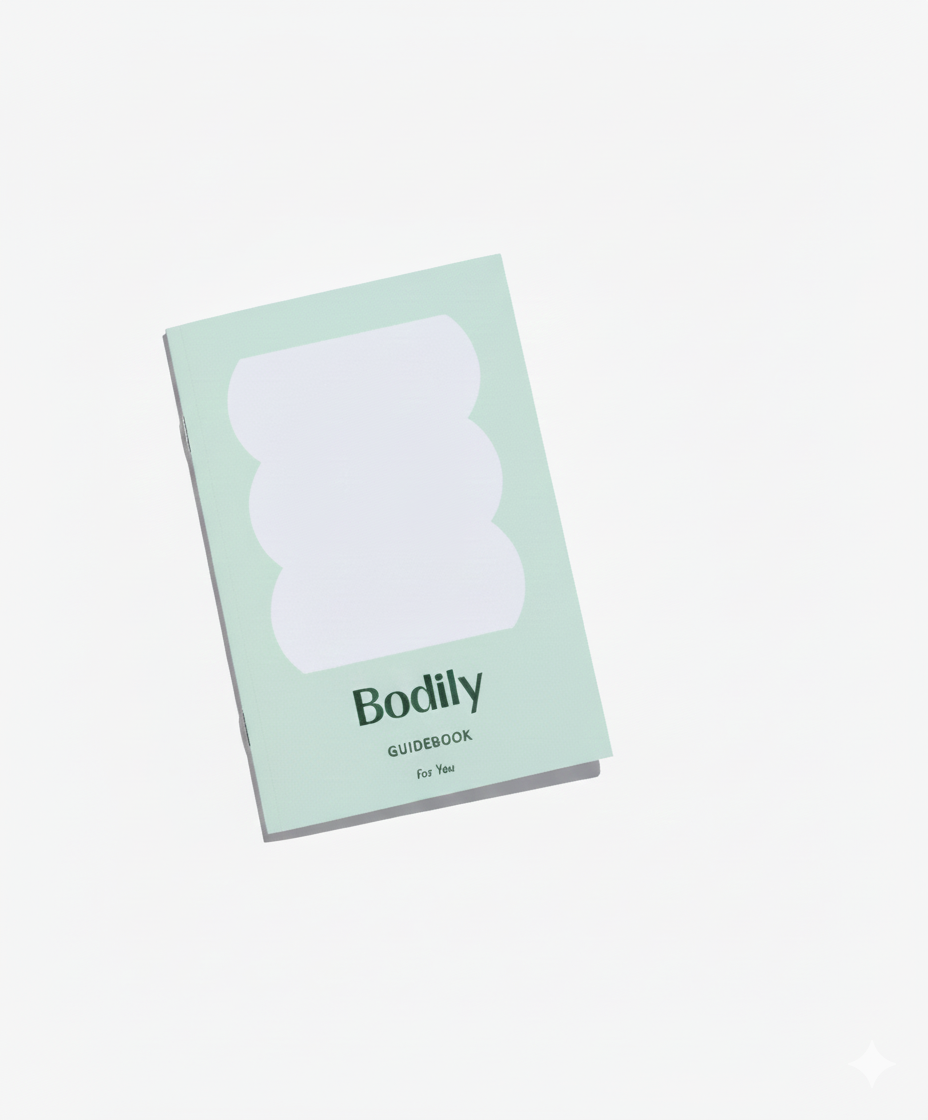 A light green Guidebook for You lies on a white surface, featuring a white abstract shape on the cover.