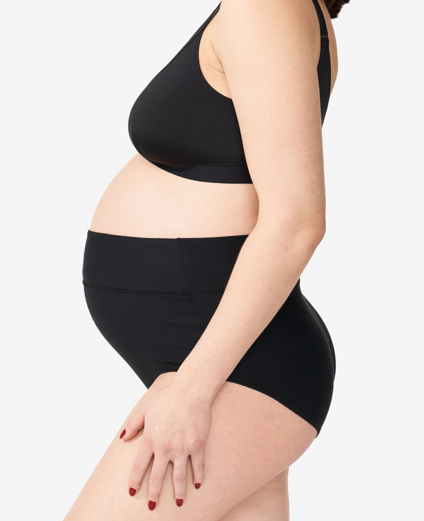 Wide band elastic waist is high enough to stay put on a pregnancy bump or healing core while covering a C-section incision without rubbing. Nicole, size 6 pre-pregnancy and 36 weeks pregnant, wears size Medium. Shown in Black.