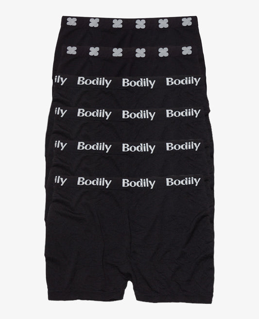 Six pairs of black mesh underwear are stacked in a row. Each waistband has “Bodily” in white text, while the top pair features a white floral pattern—ideal for postpartum bleeding or recovery after loss. Mesh Underwear: 6-Pack • Save 10%.