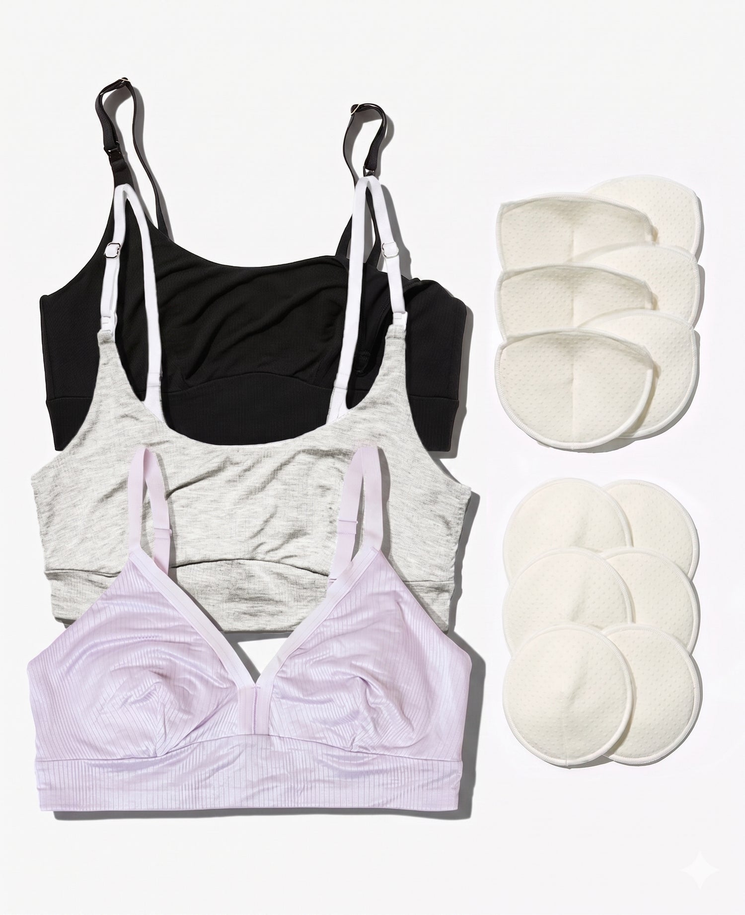 The Stage 1 Starter Kit • Save 20% features three breastfeeding bras in black, gray, and light pink laid flat beside twelve reusable breast pads in two groups on a white background.