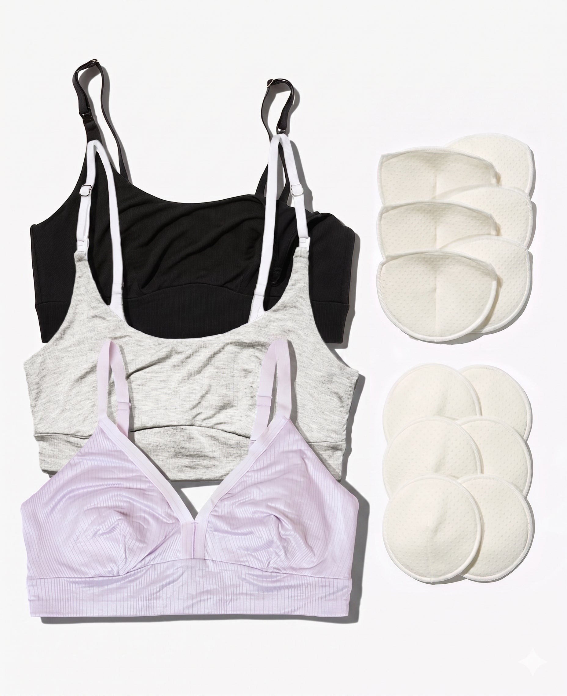 The Stage 1 Starter Kit • Save 20% features three breastfeeding bras in black, gray, and light pink laid flat beside twelve reusable breast pads in two groups on a white background.