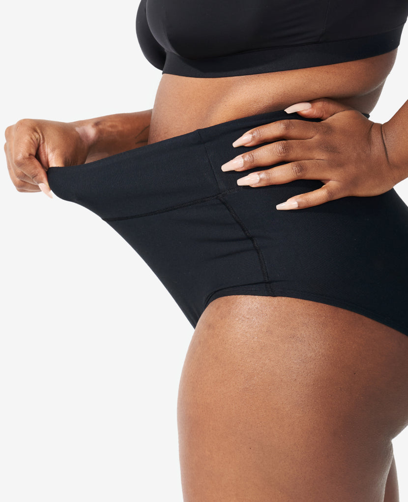 Wide band elastic waist is high enough to gently hug a pregnancy bump or healing core while covering a C-section incision without rubbing. AIP 5-Pack here is shown in Clay/Black/Grey.