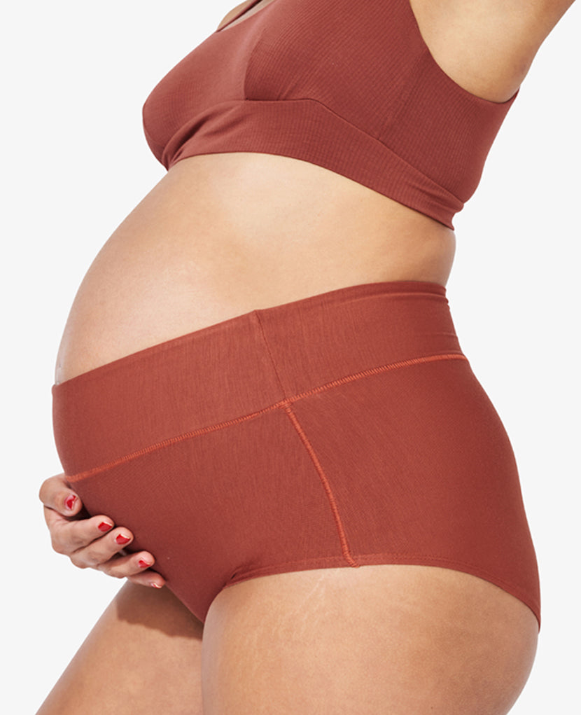 Ultra-stretchy in all the right places — from the waist to the inner thigh — to accommodate swelling and maternity & postpartum body fluctuations. Model is 28 weeks pregnant and wearing a size L. Ember/Clay/Grey 3-pack.