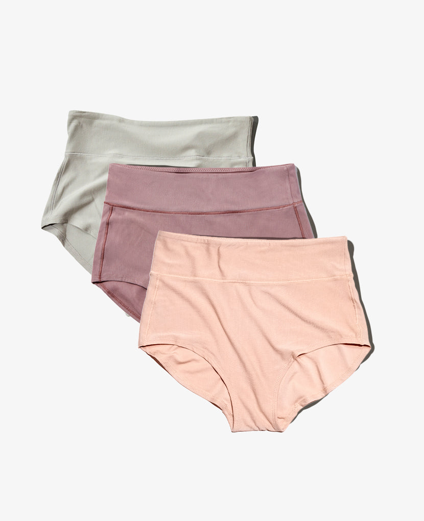 The All-In Panty: 3-Pack • Save 16%—three high-waisted panties in light gray, mauve, and pale pink, overlapped on a white background. Perfect for comfortable postpartum wear.