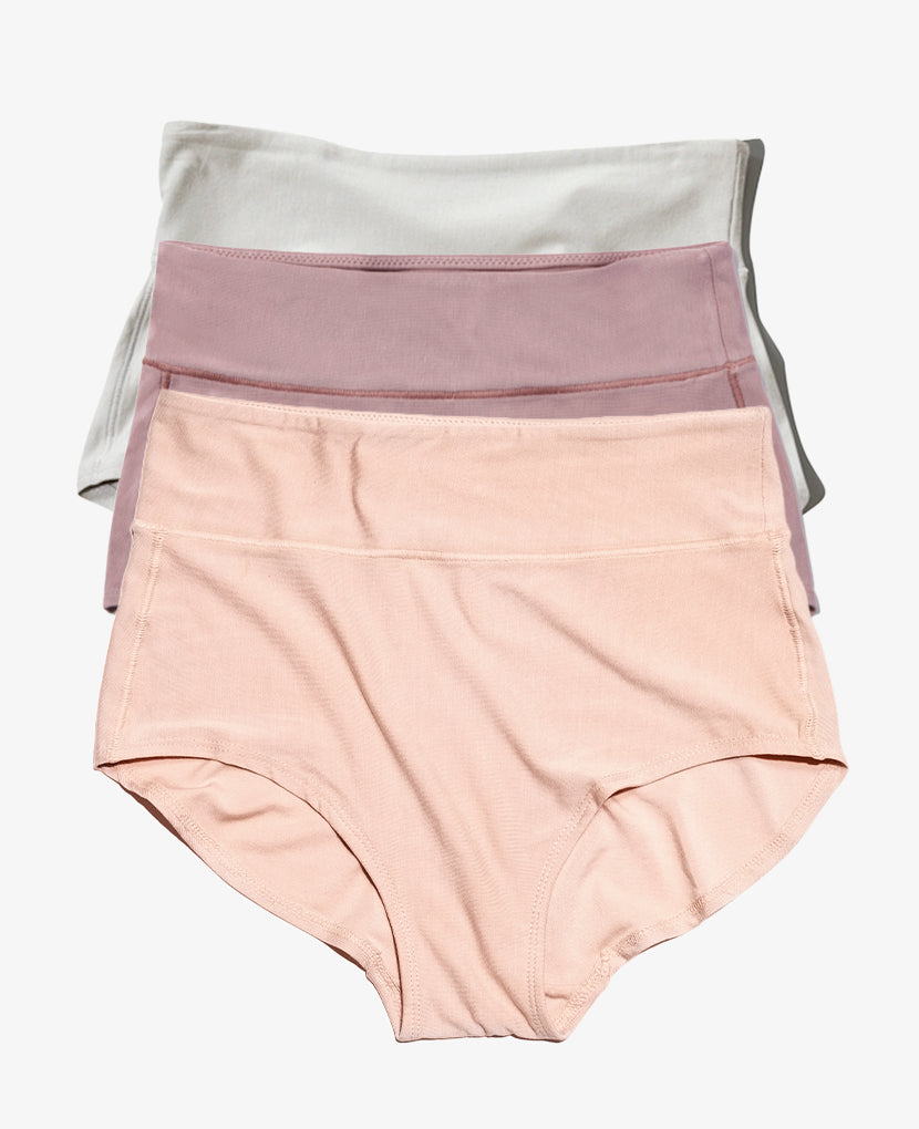 The All-In Panty: 3-Pack • Save 16% features three high-waisted panties in pastel shades (white, mauve, peach), stacked neatly—ideal for comfortable maternity and postpartum support.