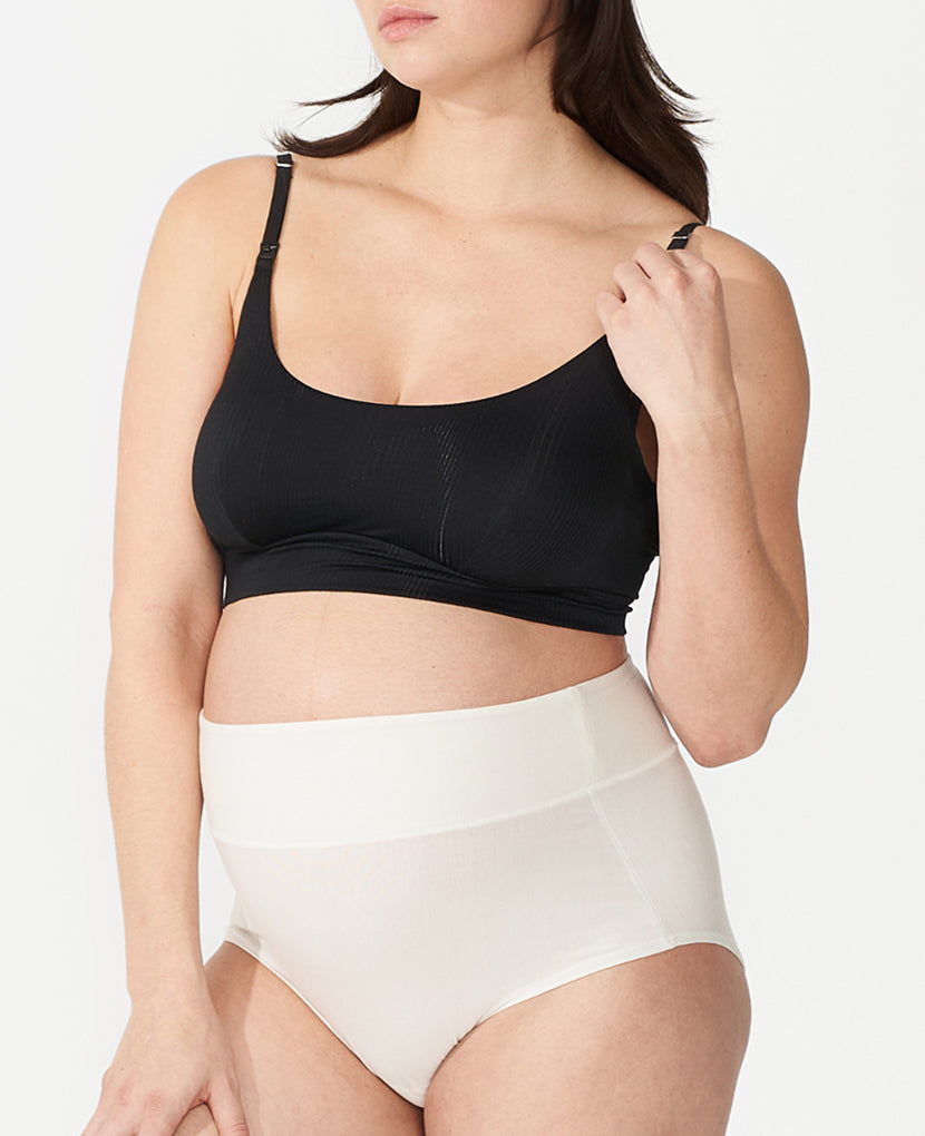Woman wearing a black bra and white high-waisted underwear on a plain background  in Black/Dusk/Slate