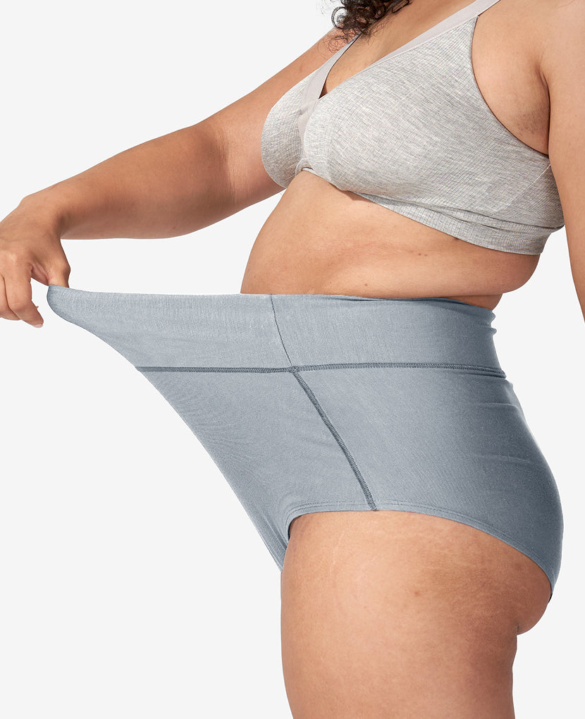 Person wearing a gray sports bra and grey high waisted underwear on a white background  in Black/Dusk/Slate