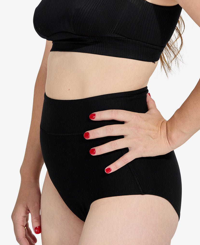 Person wearing a black bikini set with a plain background in Clay/Dusk/Grey
