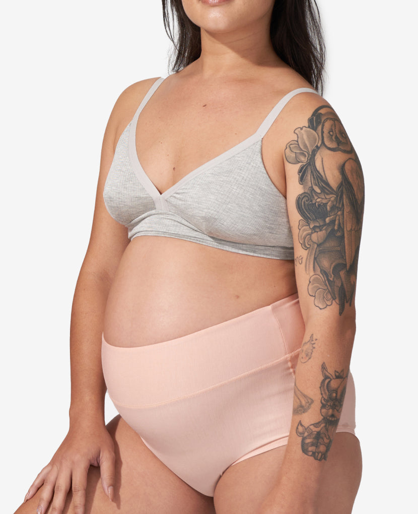 Woman wearing a light gray bra and pink underwear on a white background in Clay/Dusk/Grey