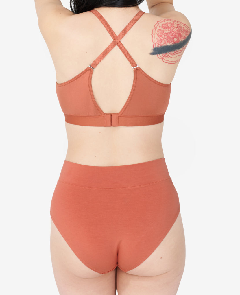Postpartum support that feels more like a pre-pregnancy panty, with a wide gusset to comfortably hold a maxi pad and a cheeky rear. Ara, size 4 and 10 months postpartum, wears a Small in Sandstone.