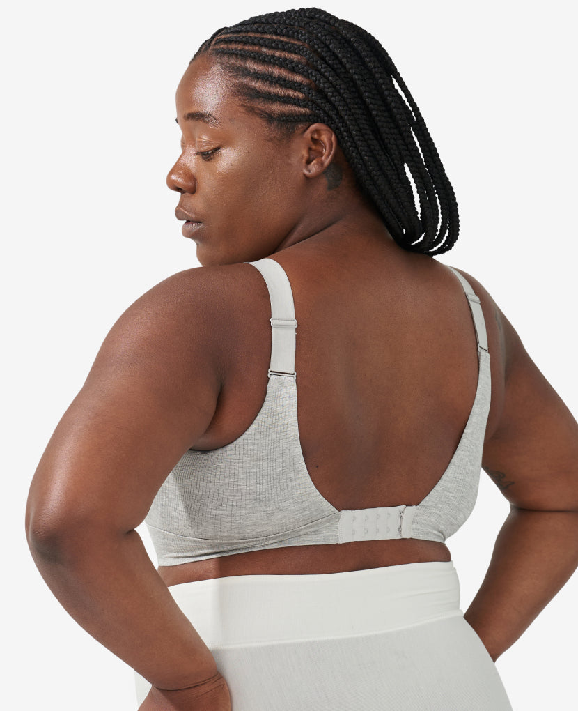 Both bras include our custom five-row back closure to accommodate your body’s incredible changes from pregnancy all the way through postpartum. Tahirah, 38D, is 8 months postpartum and wearing The Effortless Bra, size L in Grey Marl.