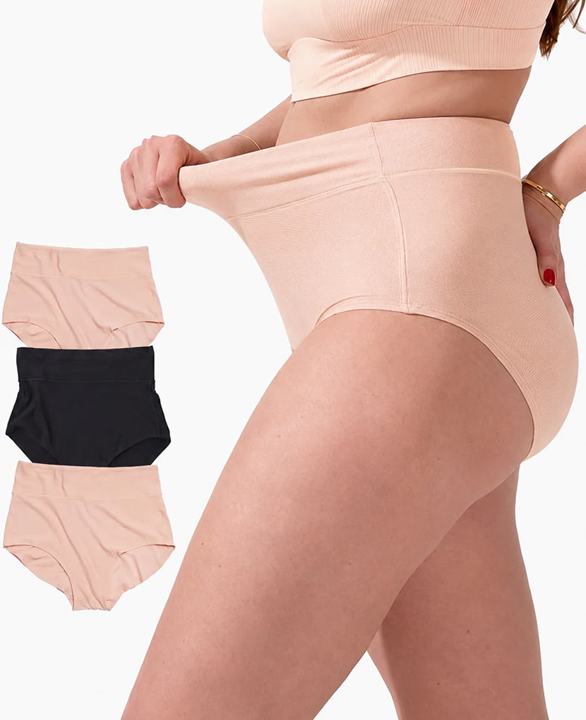 A model wearing high-waisted seamless briefs in a light peach-beige color, stretching the fabric at the waistband to show elasticity. Three smaller inset images on the left show the product in three colors: peach-beige, black, and light peach-beige, against a plain white background. shown in Black/Clay/Clay