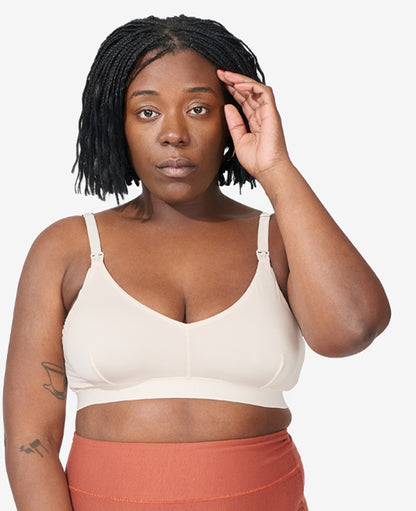 Sizes L and XL feature thicker straps for comfort. The V-shaped neckline and smoothing fabric layer easily under clothes. Tahirah wears a L in Shell.