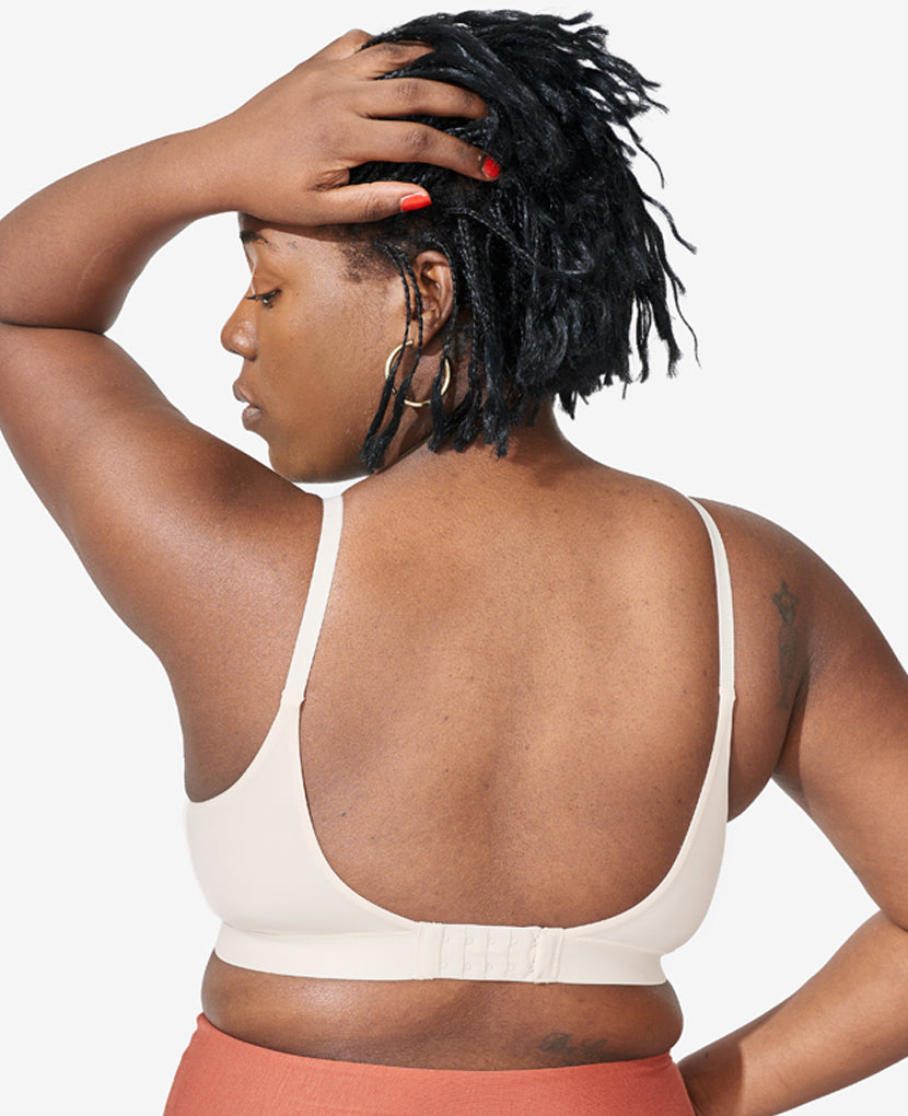 Our custom, signature five-row extended back closure offers increased adjustability. Tahirah, 38D, and wears size Large in Shell.