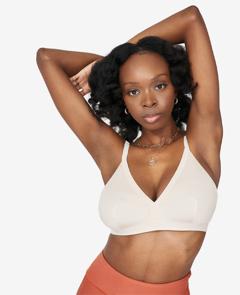 Meet the So Easy Bra in Shell. Sleek design, subtle support, and smooth fabric. Yanni is size 34DD and wears a size Medium.